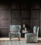 Lamp on round table against wooden wall in dark black empty interior with carpet